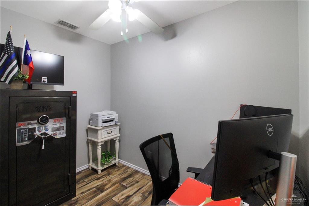 21412 Rusty Lane Harlingen, TX 78552 - Photo 15 of 35 a view of a workspace with furniture and a fan