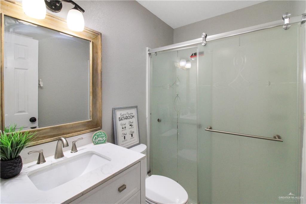 21412 Rusty Lane Harlingen, TX 78552 - Photo 18 of 35 a bathroom with a sink toilet mirror and shower