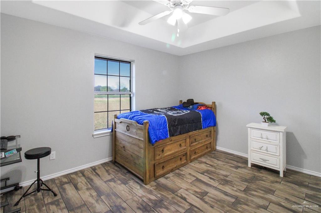 21412 Rusty Lane Harlingen, TX 78552 - Photo 20 of 35 a living room with a bed furniture and a chandelier