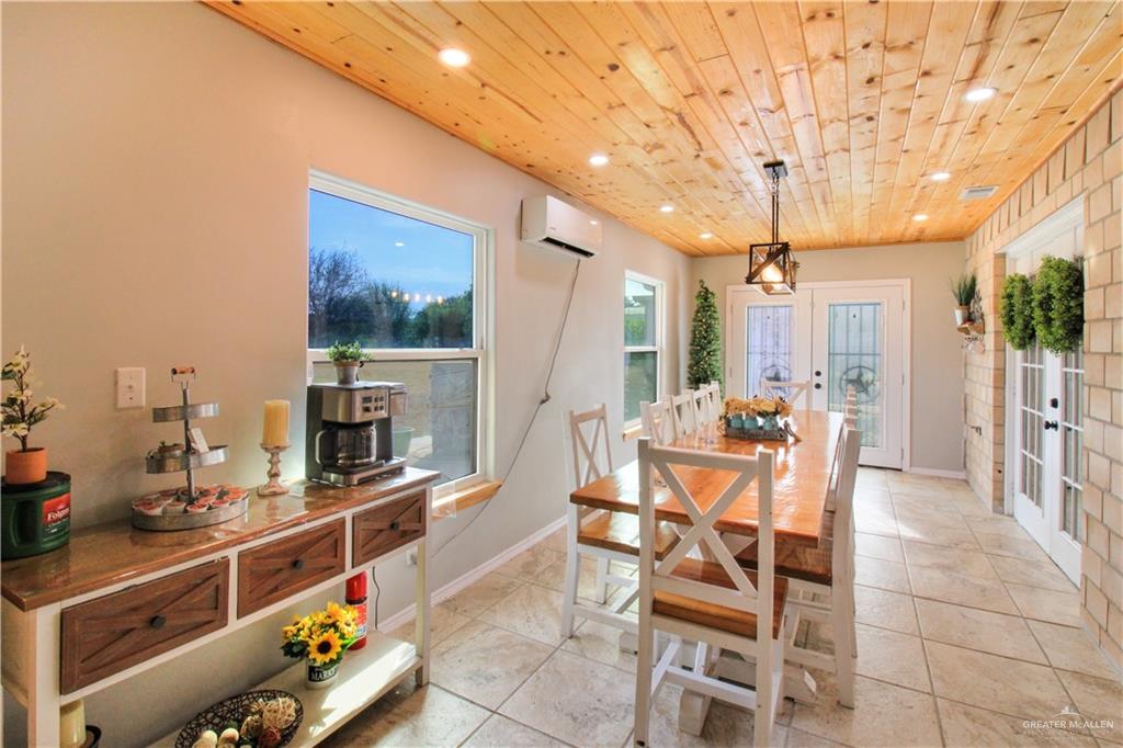 21412 Rusty Lane Harlingen, TX 78552 - Photo 7 of 35 a view of a dining room with furniture a kitchen and chandelier