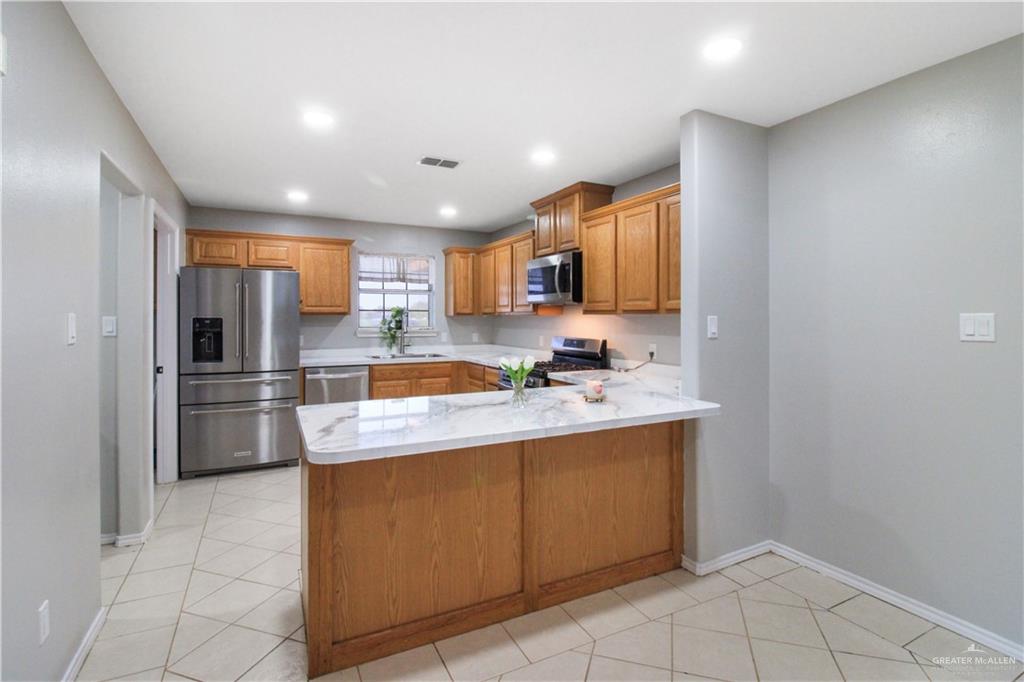 21412 Rusty Lane Harlingen, TX 78552 - Photo 8 of 35 a kitchen with stainless steel appliances granite countertop a sink stove and refrigerator