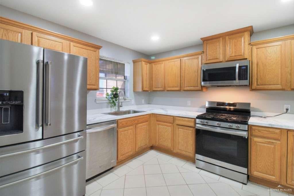 21412 Rusty Lane Harlingen, TX 78552 - Photo 9 of 35 a kitchen with granite countertop a refrigerator stove and microwave