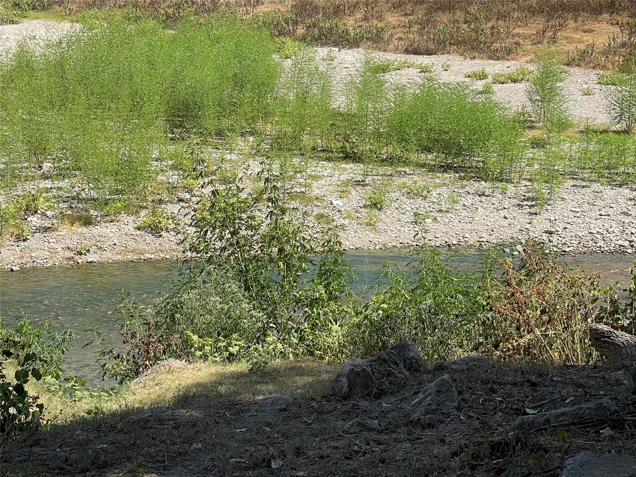 Lot 35 Cattle Trail Kempner, TX 76539 - Photo 18 of 20 Natural flowing water runs directly past a rocky, vegetated bankside terrain.