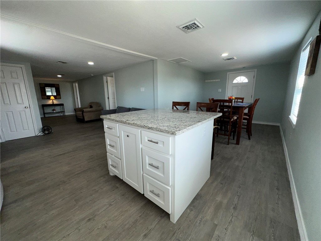 201 Volpe Circle Gregory, TX 78374 - Photo 13 of 29 a kitchen with a stove a table and chairs