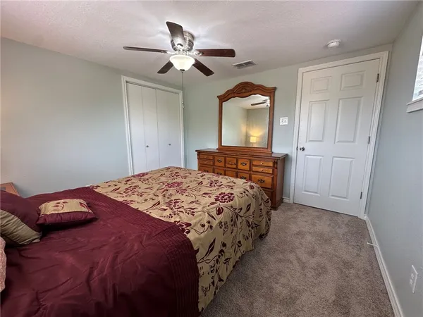 a bedroom with a bed and window