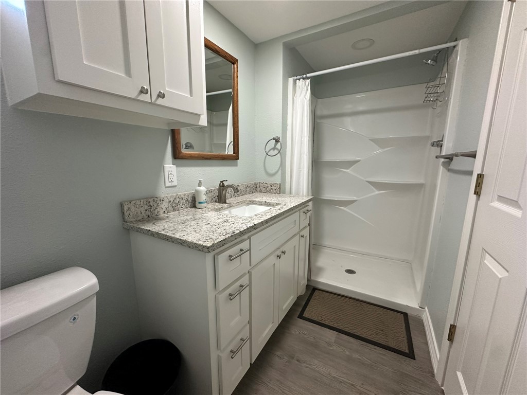 201 Volpe Circle Gregory, TX 78374 - Photo 22 of 29 a bathroom with a granite countertop sink and a mirror
