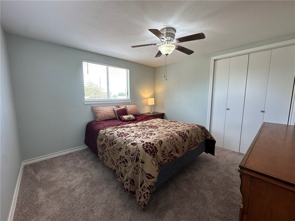 201 Volpe Circle Gregory, TX 78374 - Photo 9 of 29 a bedroom with a bed and a chandelier