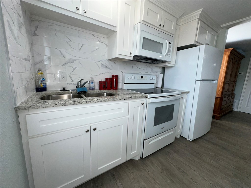 201 Volpe Circle Gregory, TX 78374 - Photo 10 of 29 a kitchen with stainless steel appliances granite countertop a sink a stove a refrigerator and cabinets