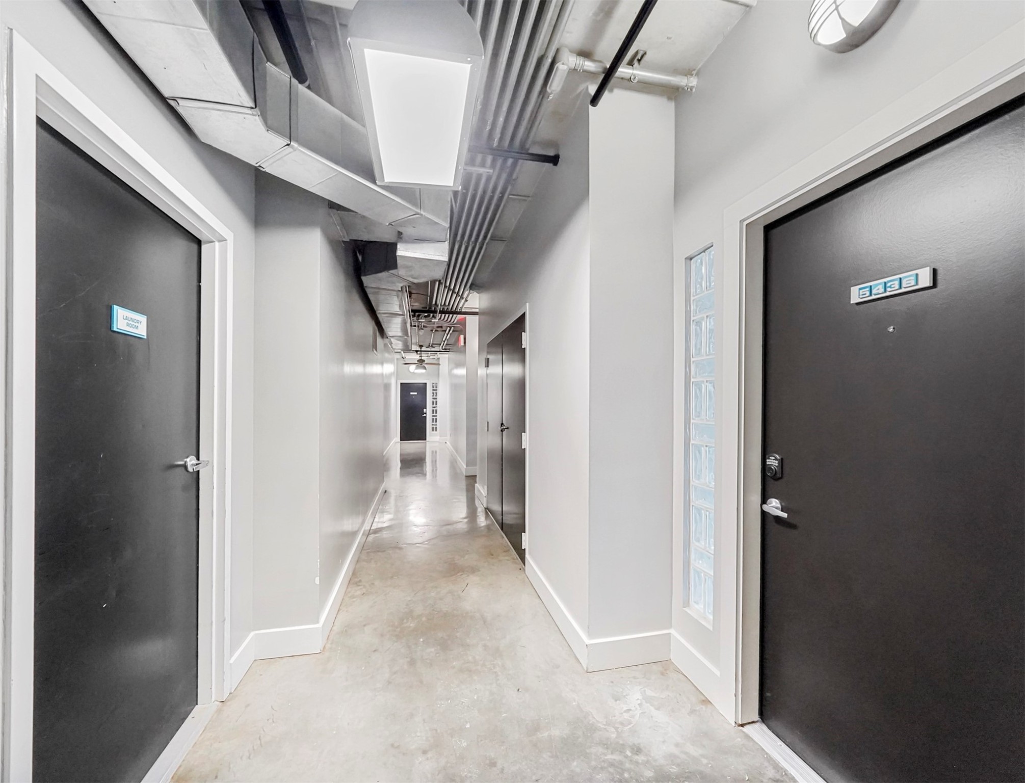 2000 Bagby Street, Unit 5436 Houston, TX 77002 - Photo 17 of 32 a view of a hallway with wooden shelves