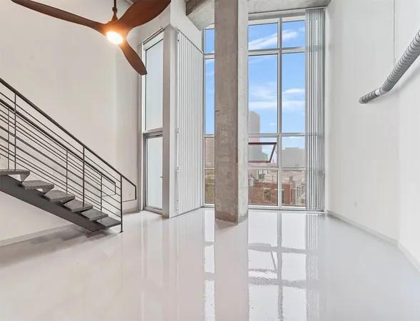 a view of staircase with white walls and windows