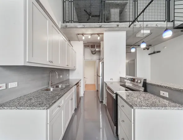 a kitchen with stainless steel appliances granite countertop a sink and cabinets