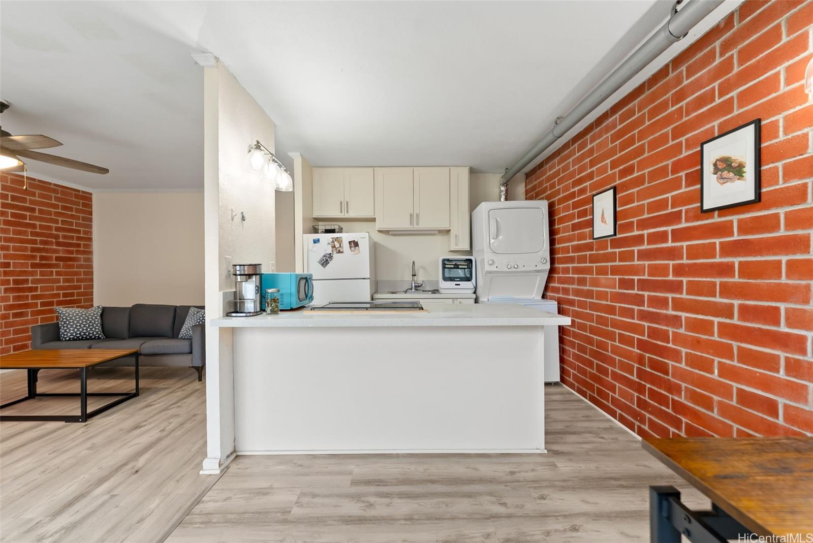 45-535 Luluku Road, Unit G3 Kaneohe, HI 96744 - Photo 11 of 25 a view of kitchen with stainless steel appliances wooden floor and chair