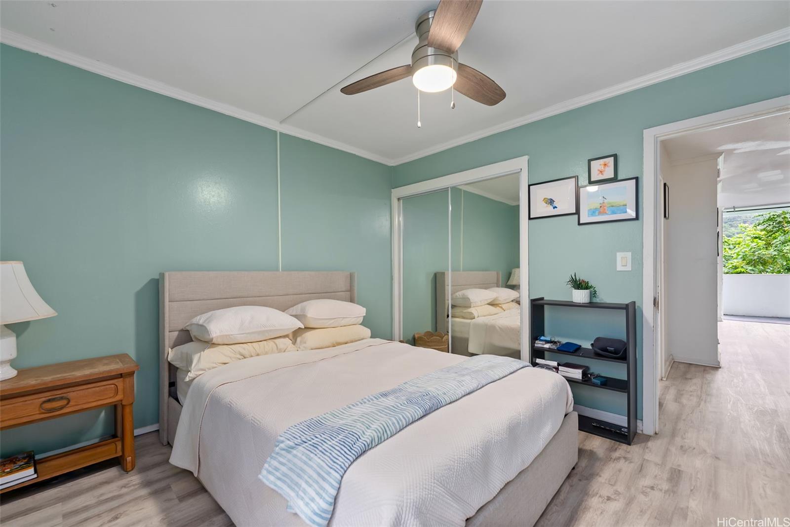 45-535 Luluku Road, Unit G3 Kaneohe, HI 96744 - Photo 16 of 25 a bedroom with a bed and a chandelier