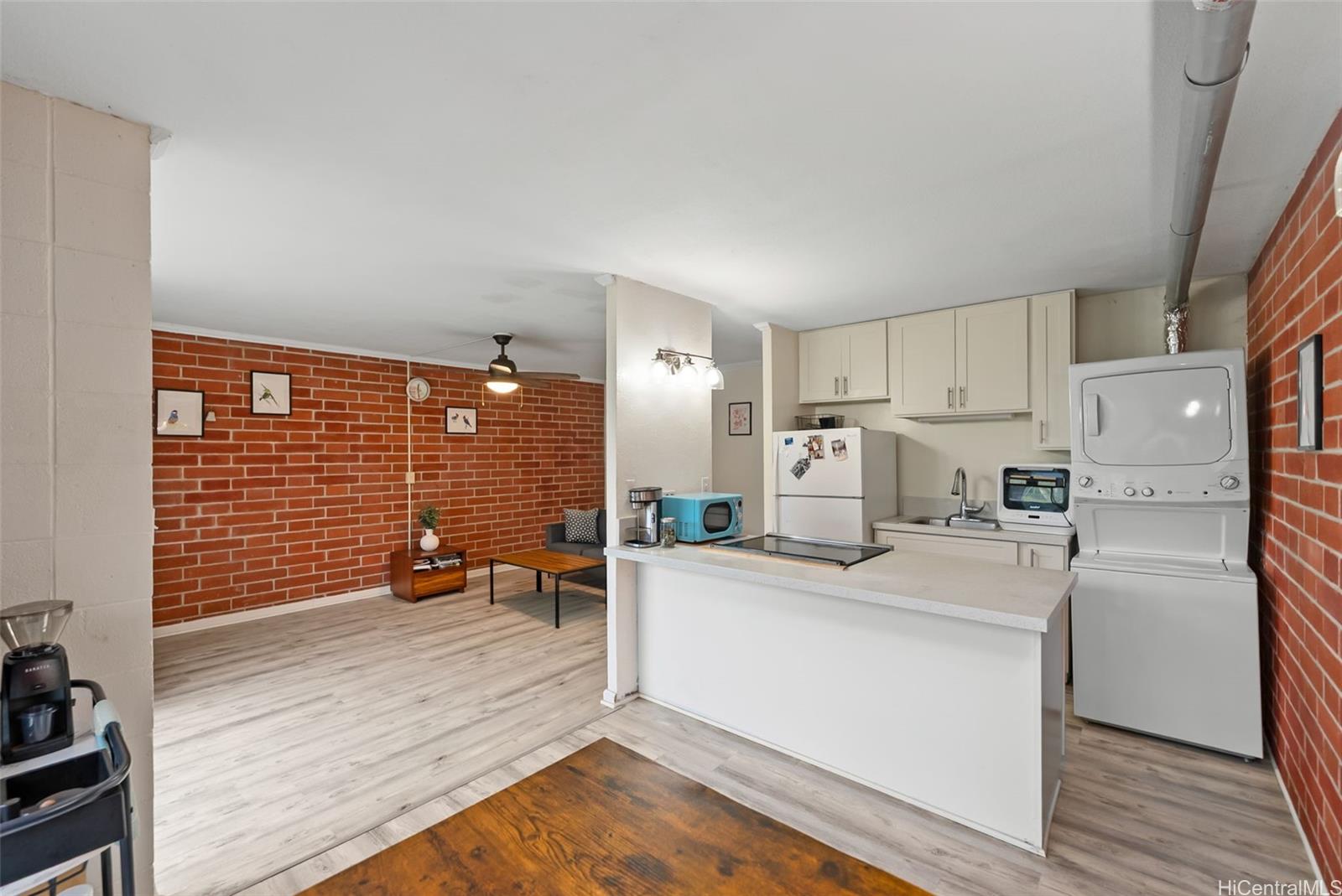 45-535 Luluku Road, Unit G3 Kaneohe, HI 96744 - Photo 10 of 25 a kitchen with stainless steel appliances a refrigerator a stove a sink and cabinets
