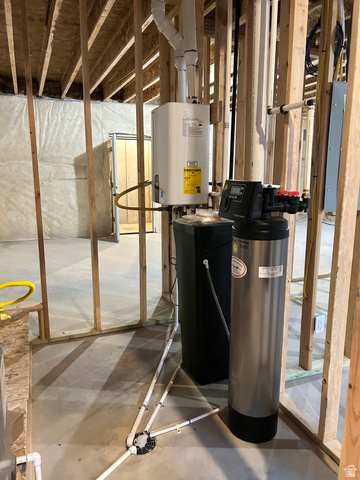6 South 450th West Gunnison, UT 84634 - Photo 39 of 45 Utility area featuring a tankless water heater, water softener system, and PEX plumbing