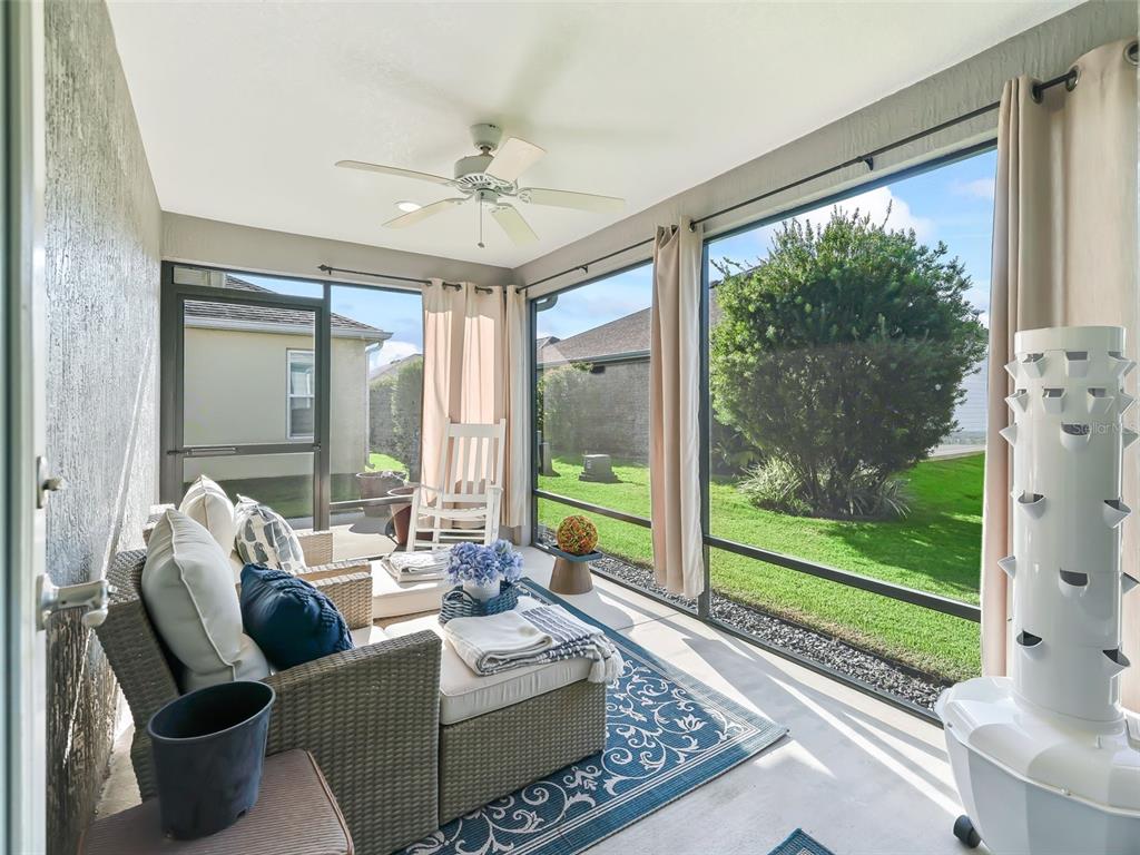 3812 Nottingham Loop The Villages, FL 32163 - Photo 11 of 30 a living room with furniture and a floor to ceiling window