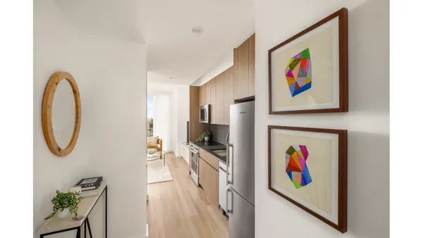 a view of a hallway with painting on the wall