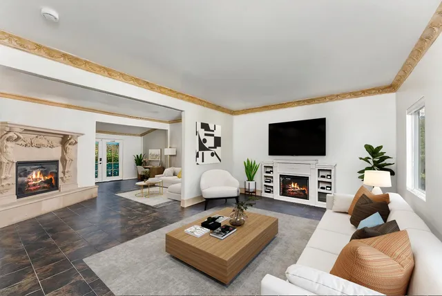 a living room with furniture a fireplace and a flat screen tv