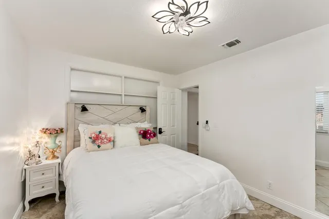 a bedroom with a bed and a window