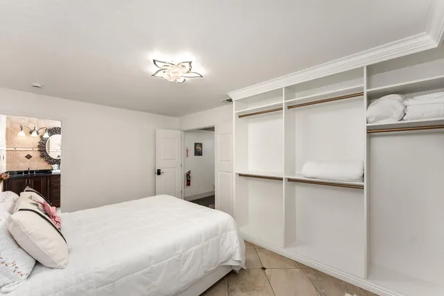 a bedroom with a bed and a ceiling fan