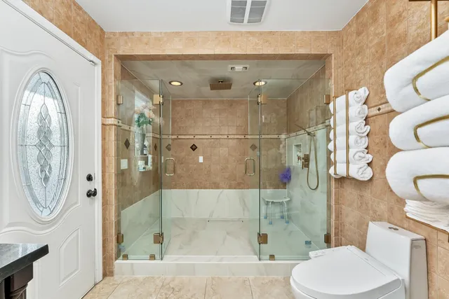 a bathroom with a toilet and a shower