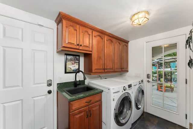 a utility room with sink dryer and washer