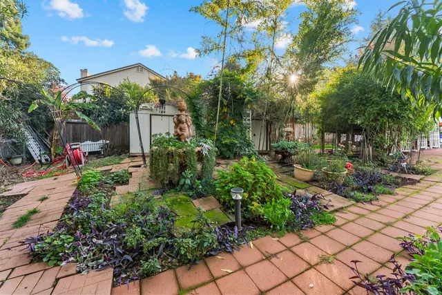 a front view of a house with a yard and fountain