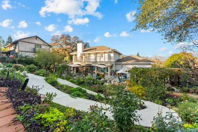 a front view of a residential apartment building with a yard