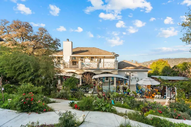 a view of a patio with a dining table and chairs under an umbrella