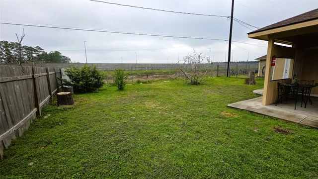 a view of a backyard with sitting area