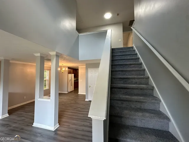 a view of entryway and hall with wooden floor