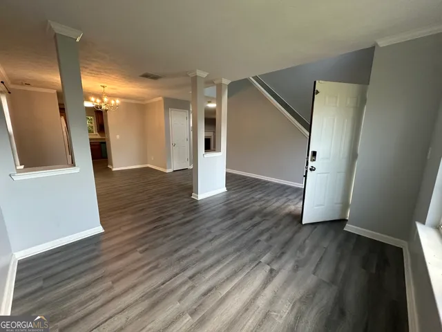 a view of a hallway with wooden floor