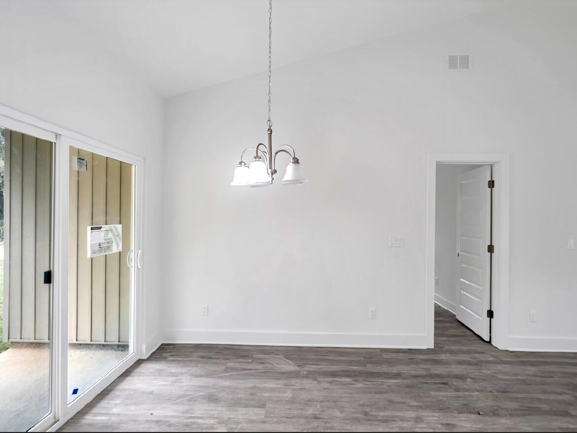 117 Buckeye Street DeFuniak Springs, FL 32433 - Photo 12 of 26 a view of empty room with wooden floor and fan