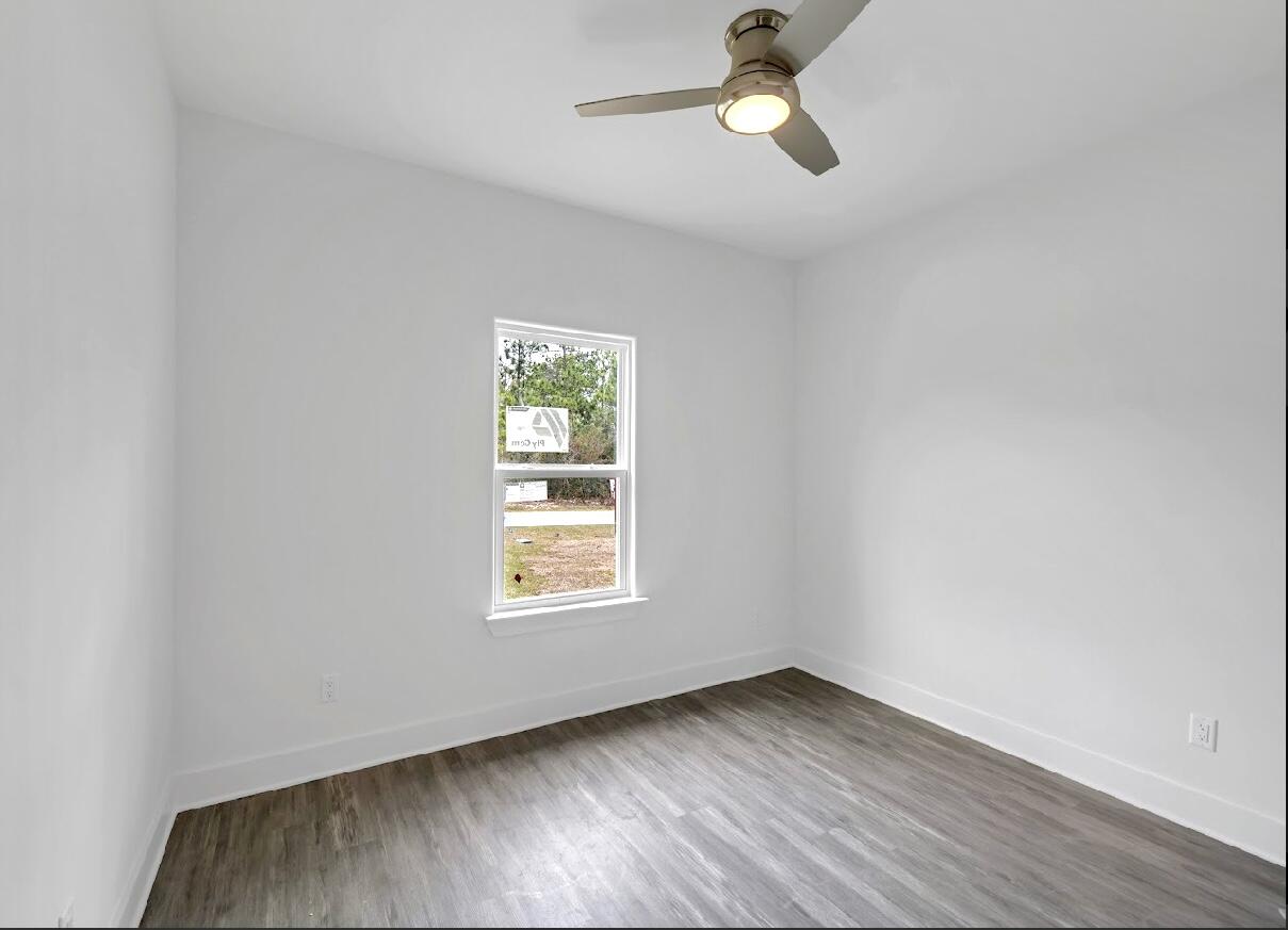 117 Buckeye Street DeFuniak Springs, FL 32433 - Photo 20 of 26 an empty room with a window and ceiling fan