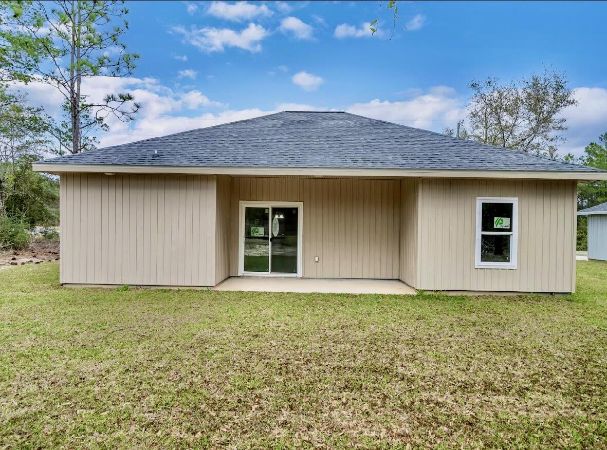 117 Buckeye Street DeFuniak Springs, FL 32433 - Photo 25 of 26 a house with garden in front of it