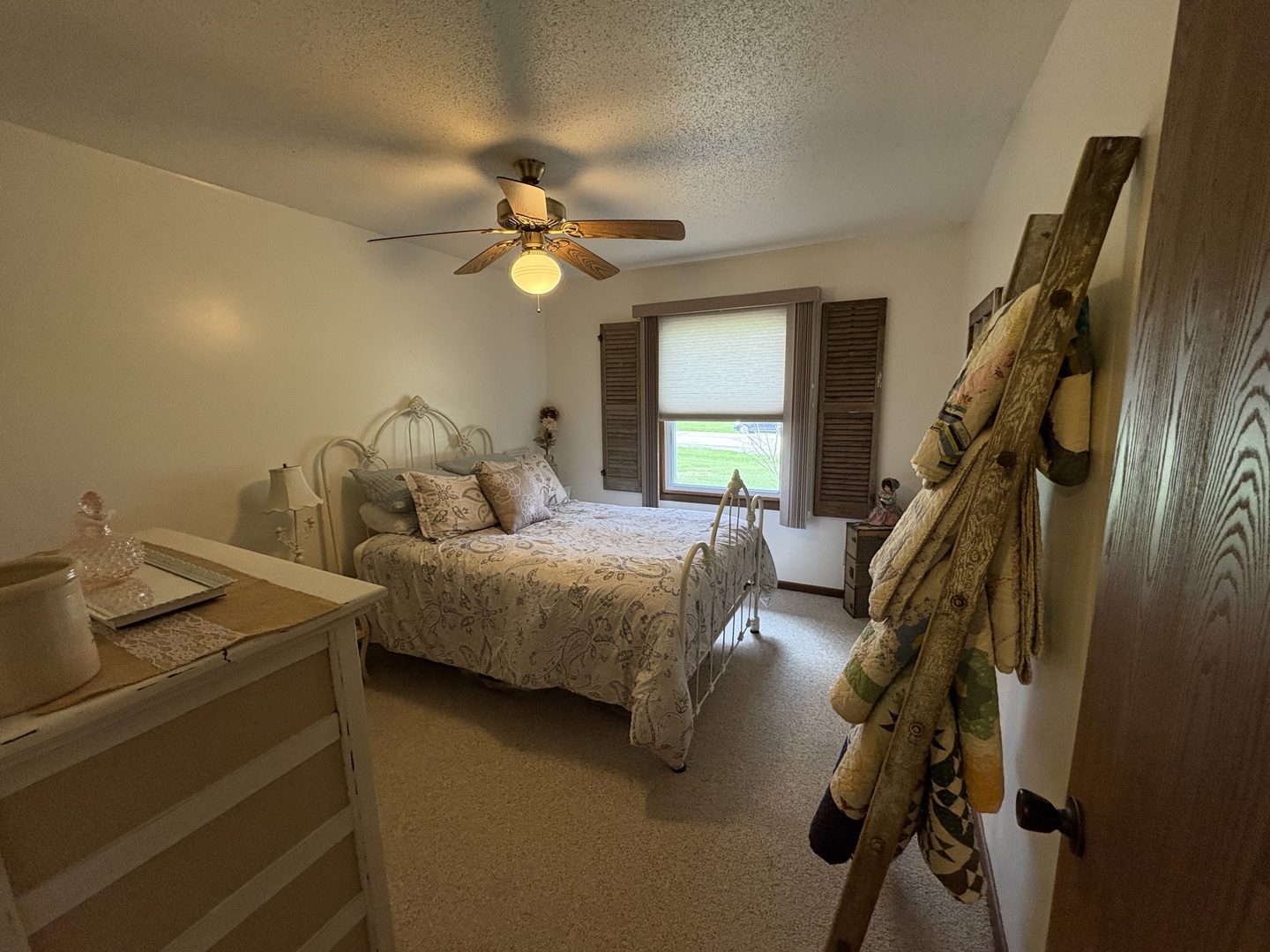 5212 South Mill Pond Road Rochelle, IL 61068 - Photo 38 of 66 a bedroom with a bed and a chandelier