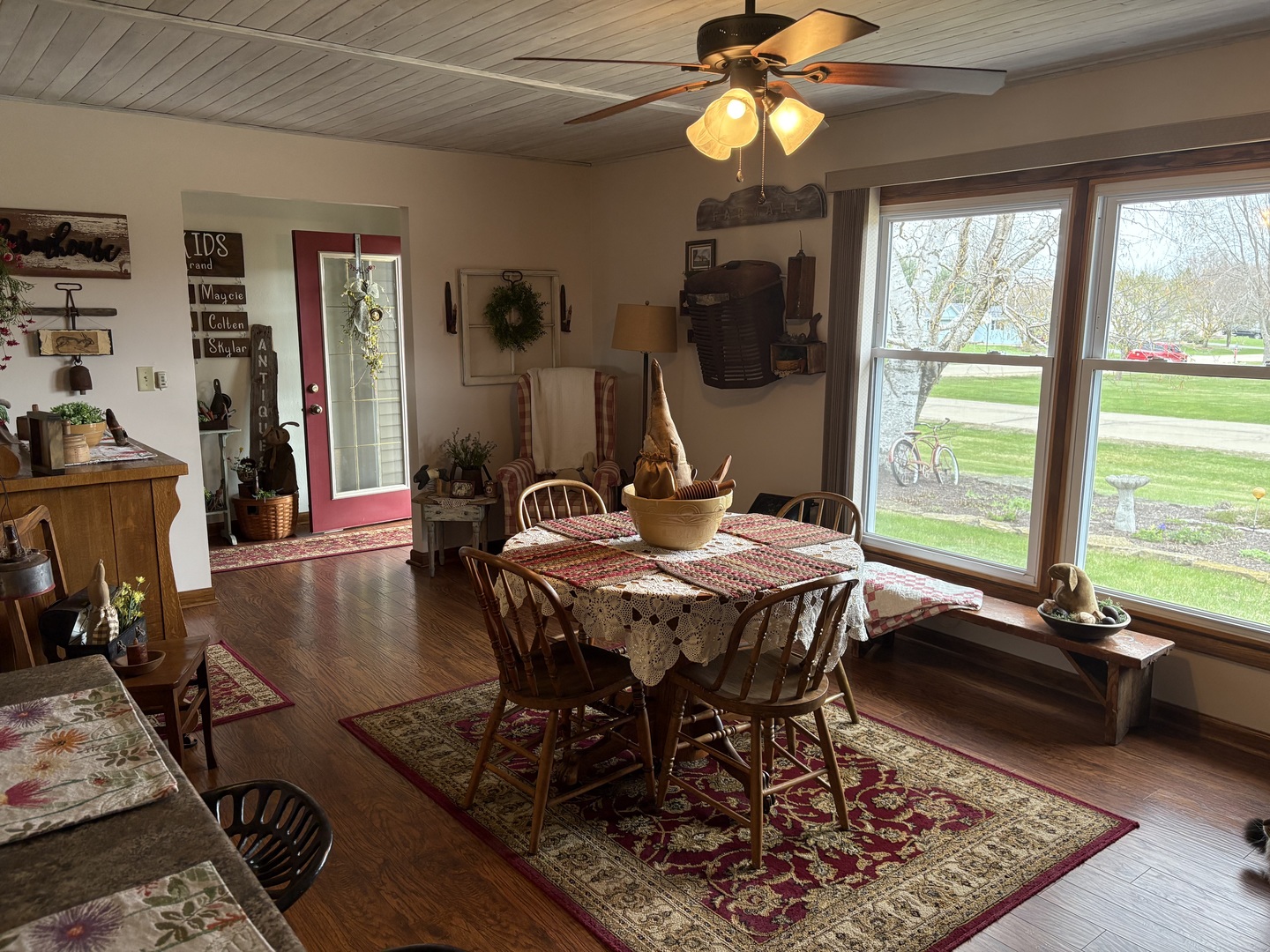 5212 South Mill Pond Road Rochelle, IL 61068 - Photo 10 of 66 a dining room with wooden floor a chandelier a wooden table and chairs