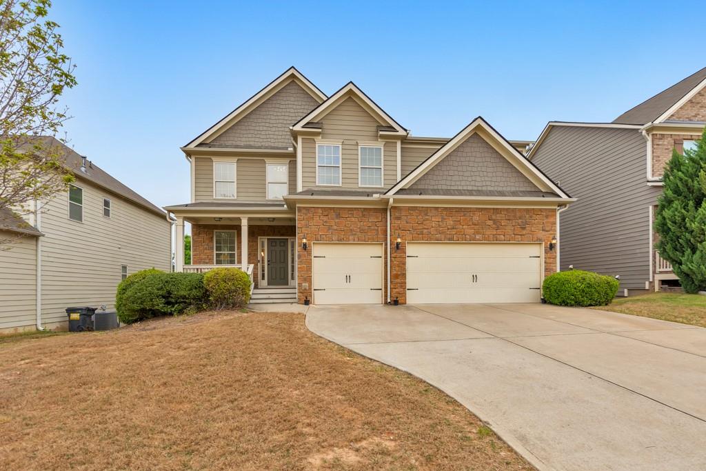 a front view of a house with a yard and garage