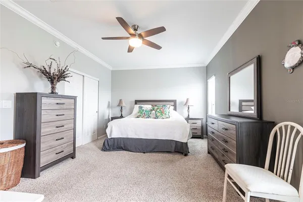 a spacious bedroom with a bed and a dresser