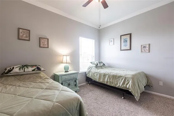 a bedroom with bed and a chandelier