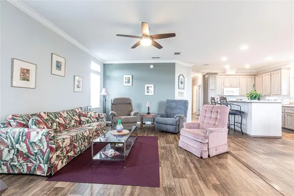 a living room with furniture and a chandelier