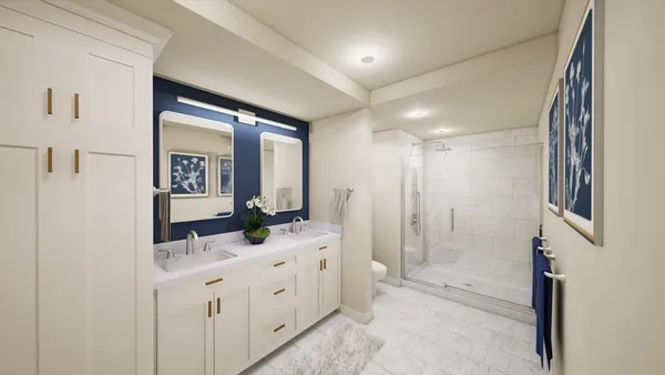 a bathroom with double vanity and a shower