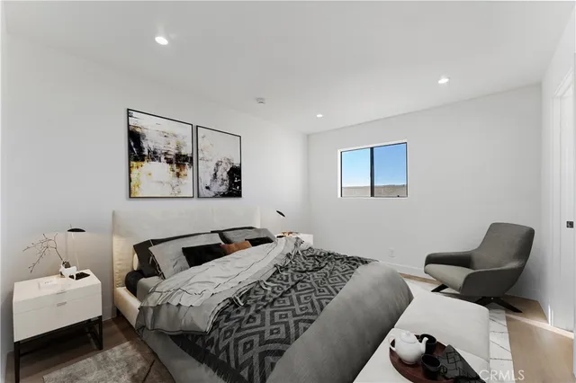 a bedroom with bed and wall painting