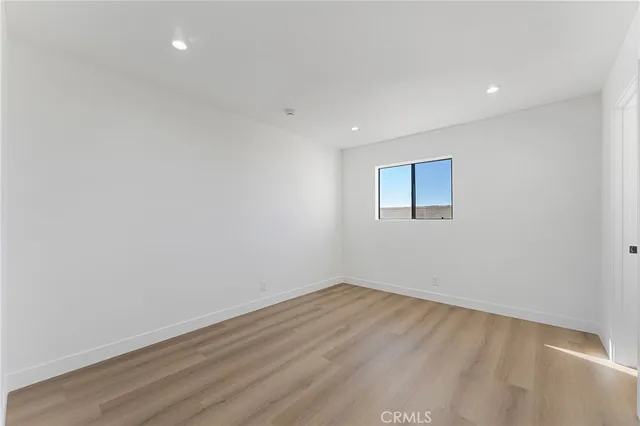 a view of a room with wooden floor and window