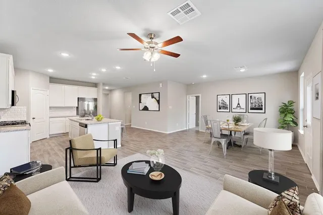 a living room with furniture and kitchen view