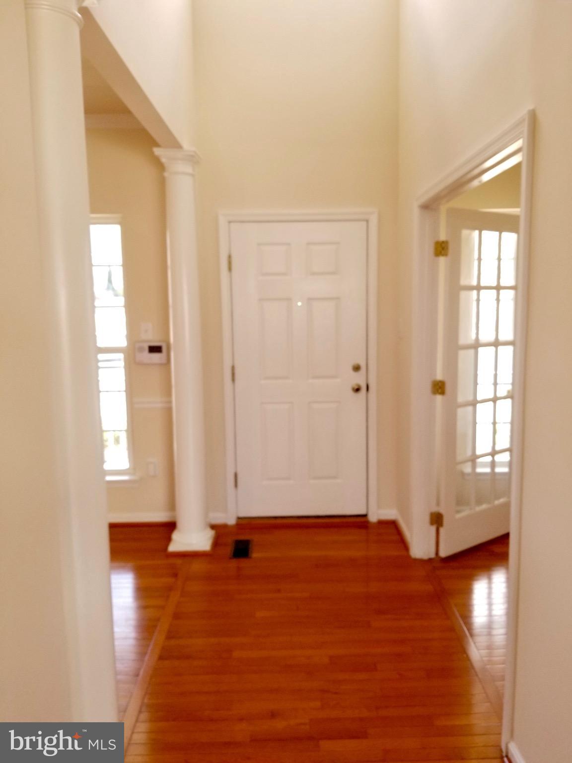 54 Watercourse Drive Ranson, WV 25438 - Photo 4 of 30 an empty room with wooden floor and windows