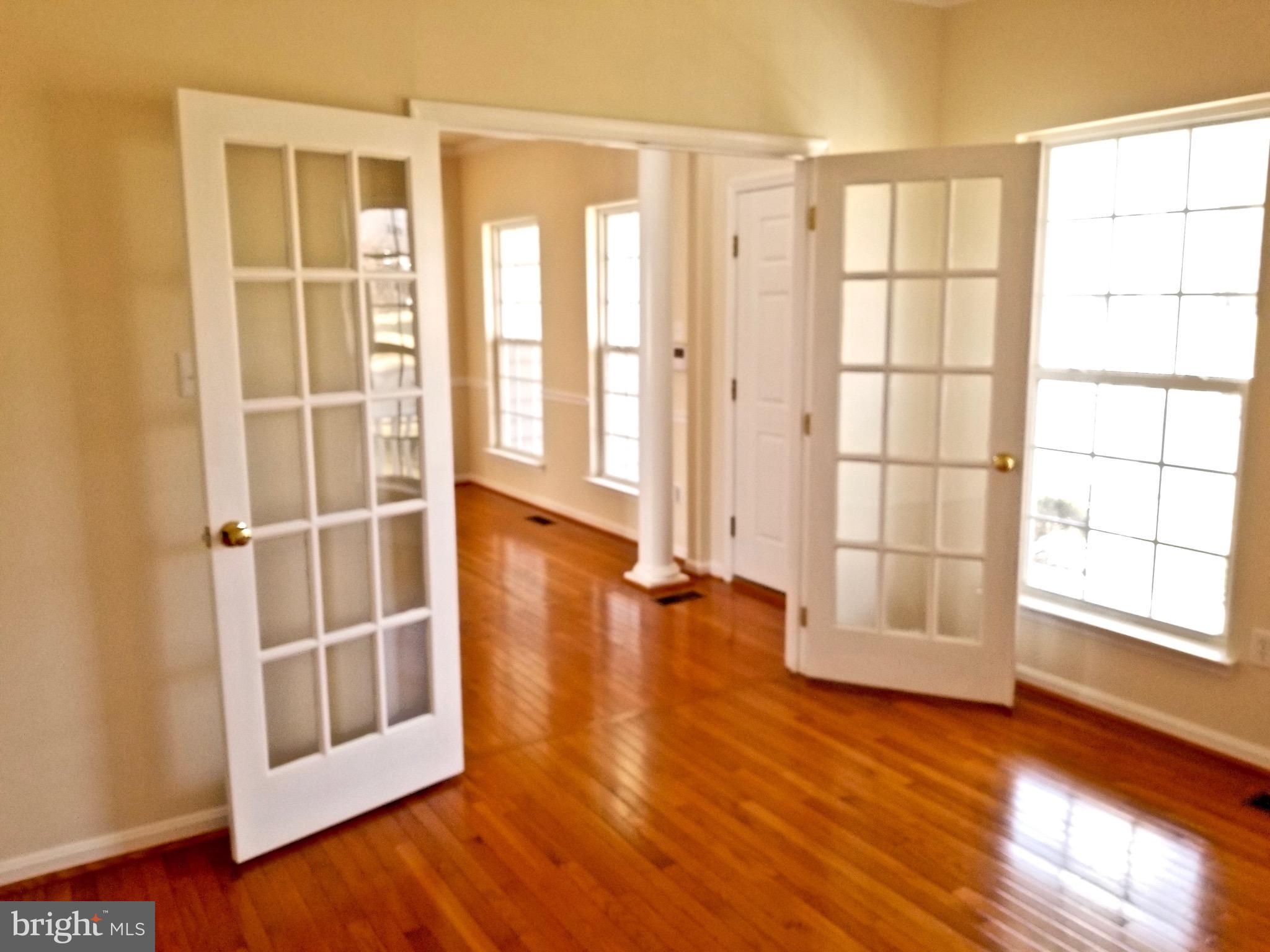 54 Watercourse Drive Ranson, WV 25438 - Photo 5 of 30 an empty room with wooden floor and windows