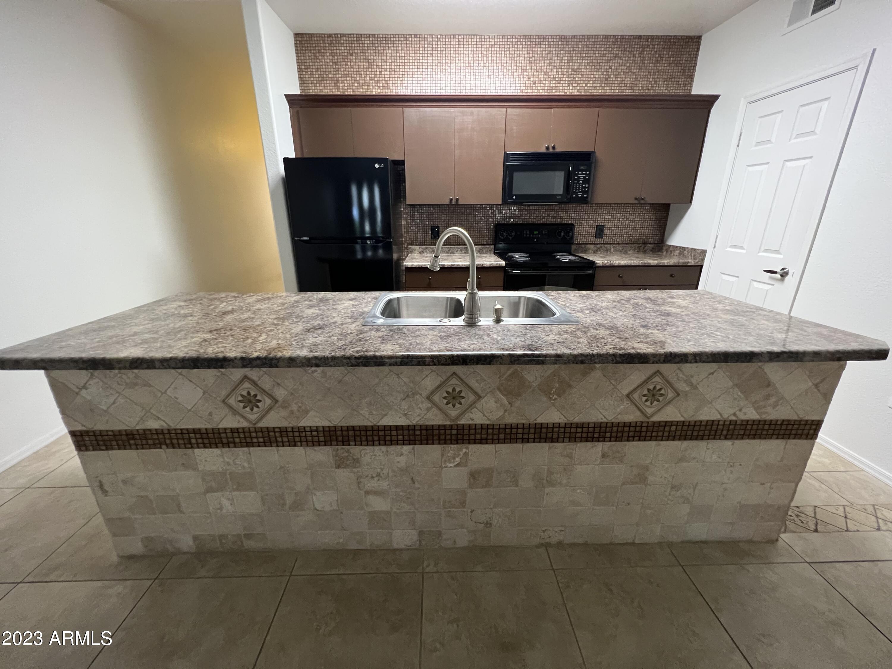 18416 North Cave Creek Road, Unit 1059 Phoenix, AZ 85032 - Photo 11 of 45 Island with Travertine surround.
