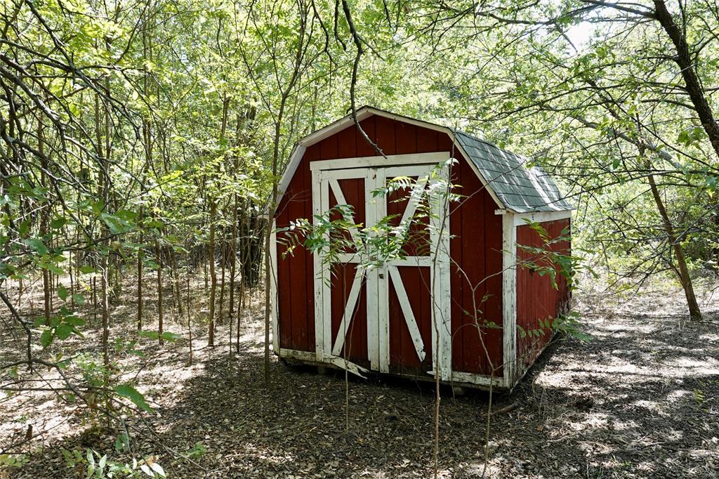 1407 West Maple Goldthwaite, TX 76844 - Photo 14 of 16 a yellow house with trees in front of it