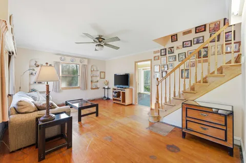 a living room with furniture or wooden floor and a flat screen tv